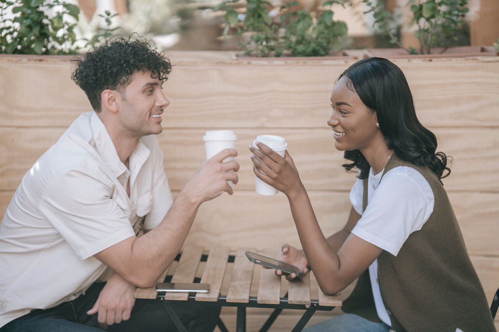 A man and woman having a respectful conversation in a café in Marakwet West