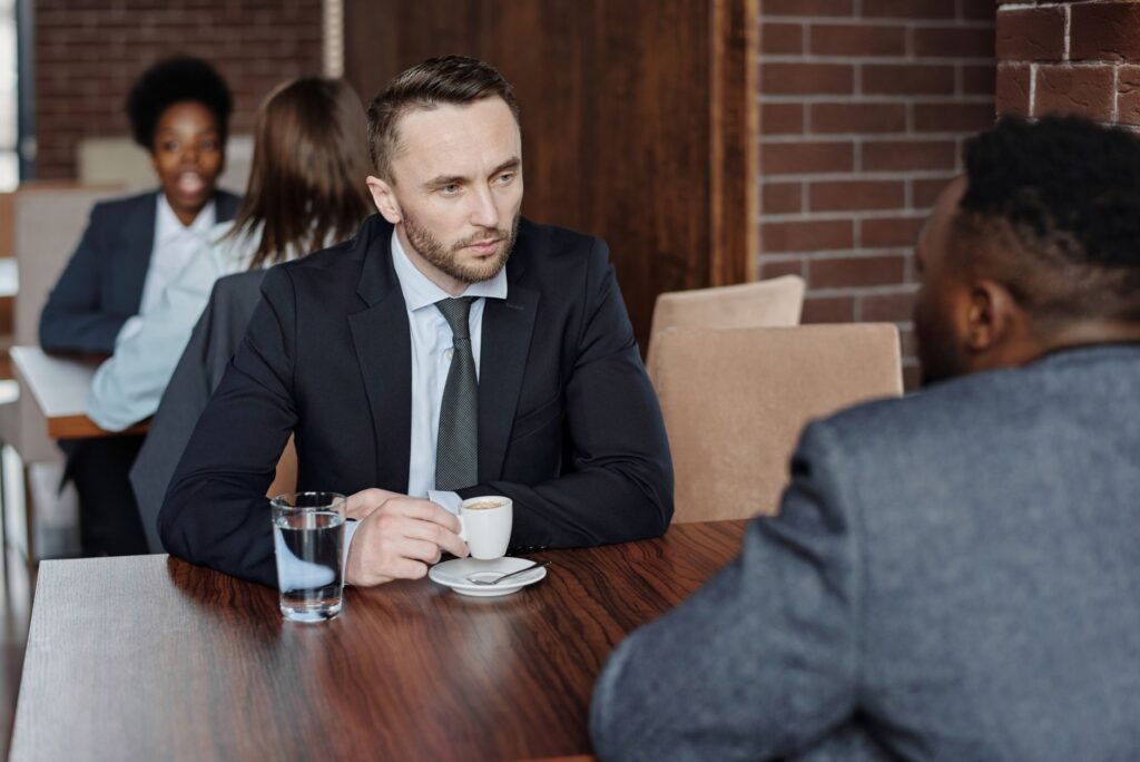 Two adults having a relaxed conversation at a café table