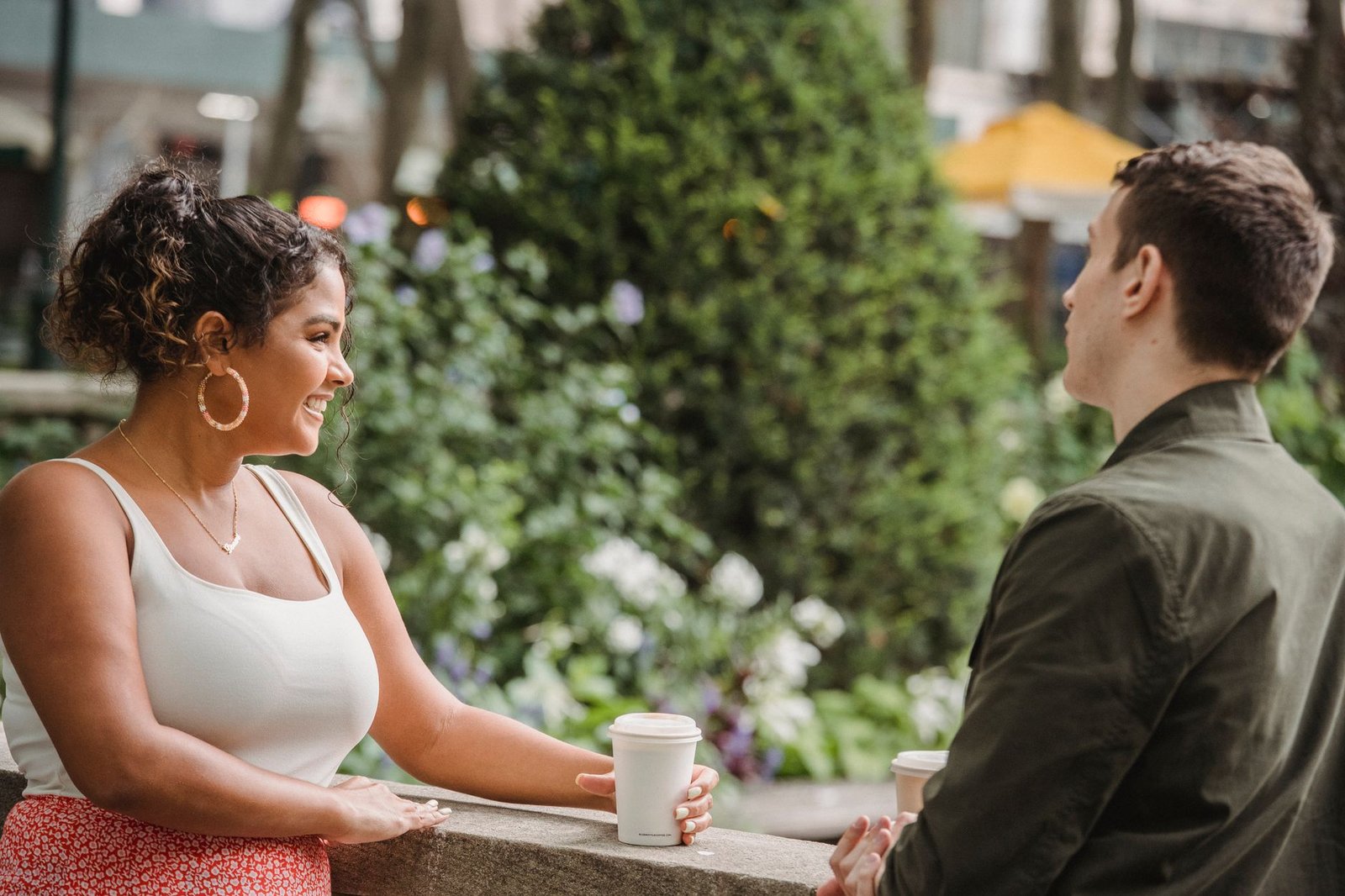Two adults in relaxed conversation at an outdoor café in a Kenyan town