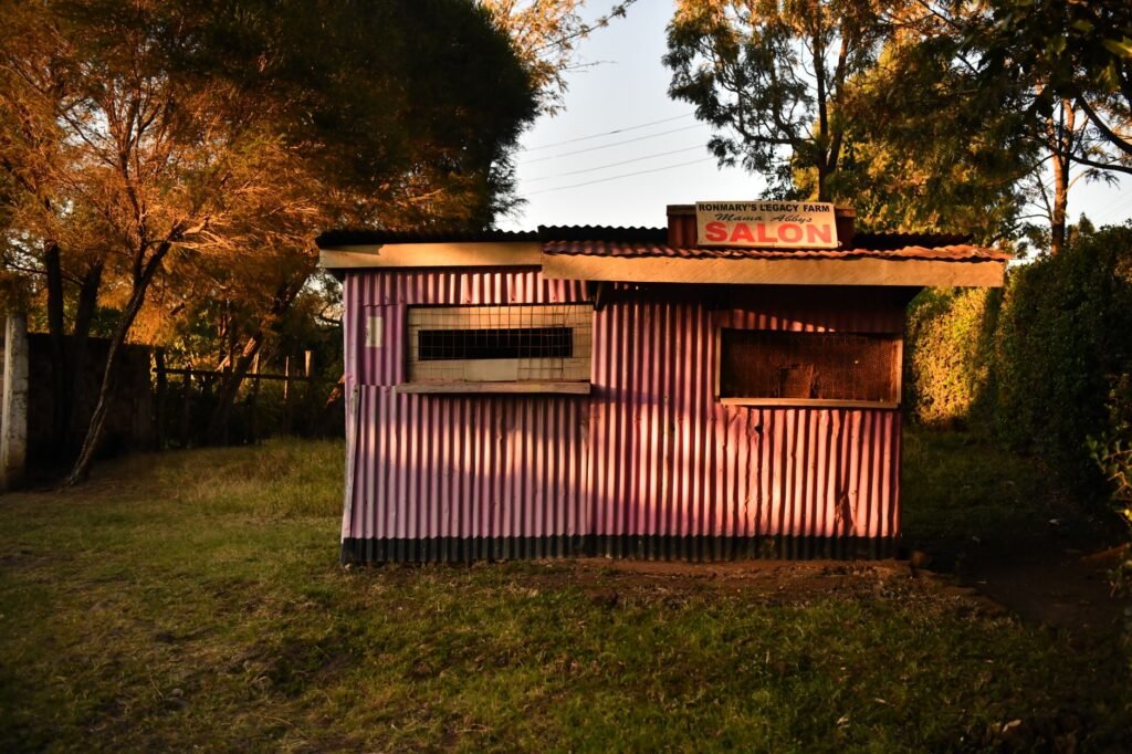 Modest guesthouse veranda in the early evening, a low-key meeting point in a small Kenyan town