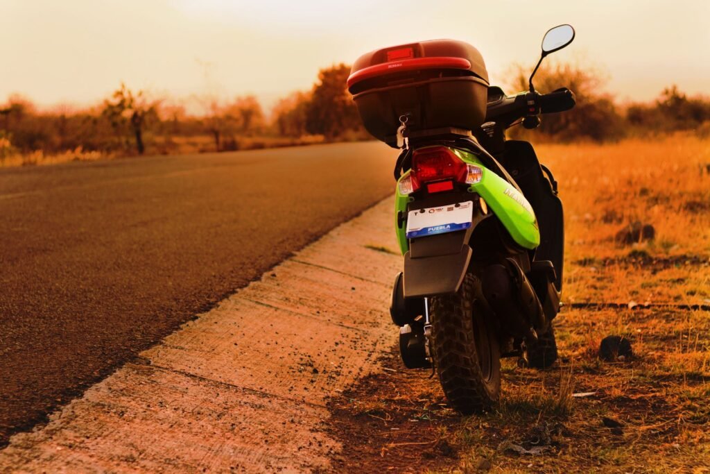 Motorcycle parked on a dusty road at twilight, illustrating the importance of arranging transport in advance