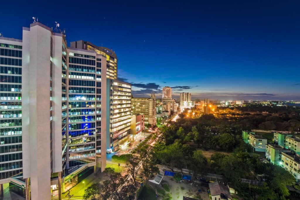 Dynamic night skyline of Dar es Salaam, showcasing illuminated city architecture.