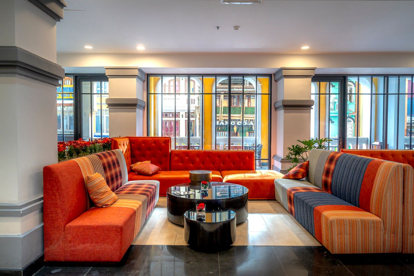 Luxury lounge area with colorful seating and modern decor in an elegant interior space.
