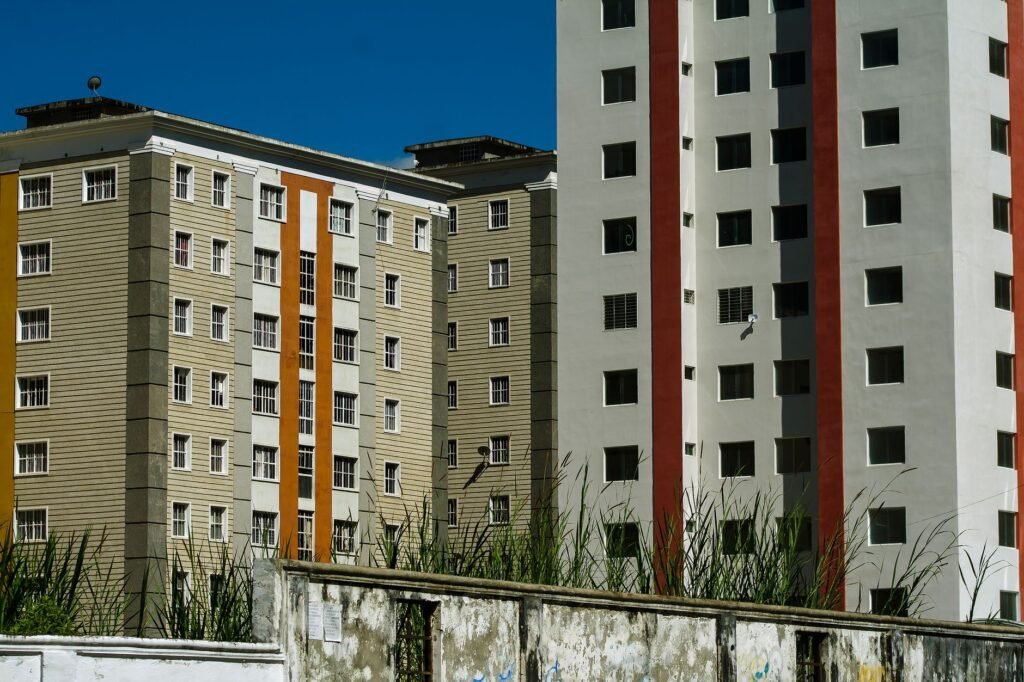 Modern apartment buildings with colorful facades against a clear blue sky in Venezuela.