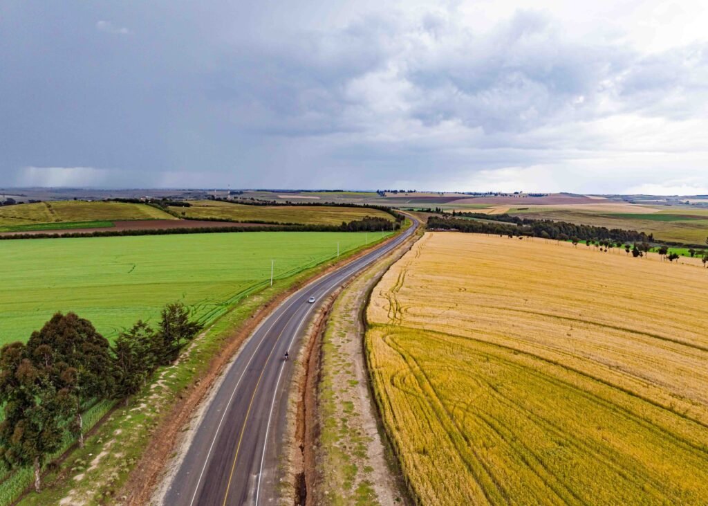 Aerial view of a road cutting through lush fields in Mau Narok, Nakuru County, Kenya.