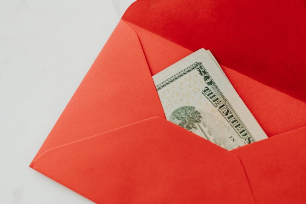 Hand placing money into an envelope, illustrating discreet and agreed payment
