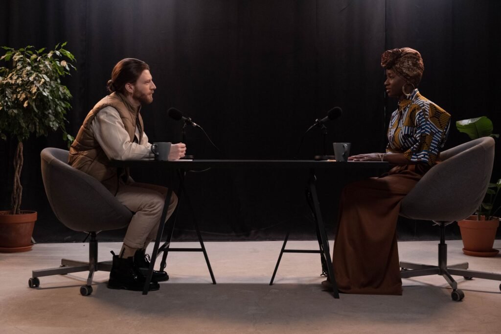 Two adults in polite conversation at a wooden table