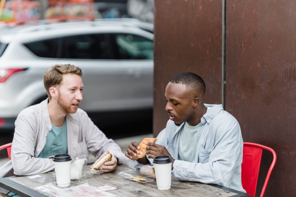 Two adults speaking politely across a cafe table in a Kenyan town