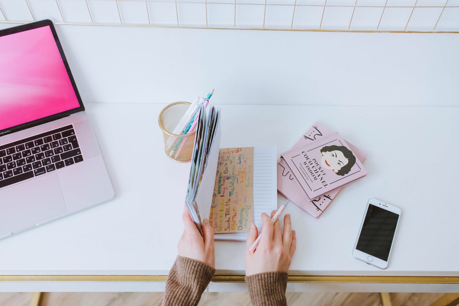 Notebook and smartphone on a wooden table used for planning a booking