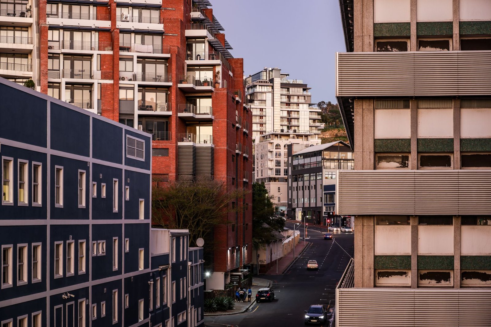 Street scene in a busy border town at dusk with soft lighting and pedestrians