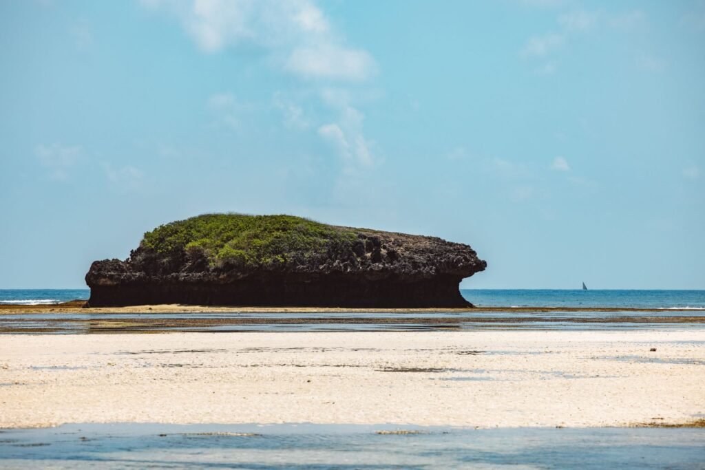 A beautiful tropical island off the coast with crystal clear waters at low tide.