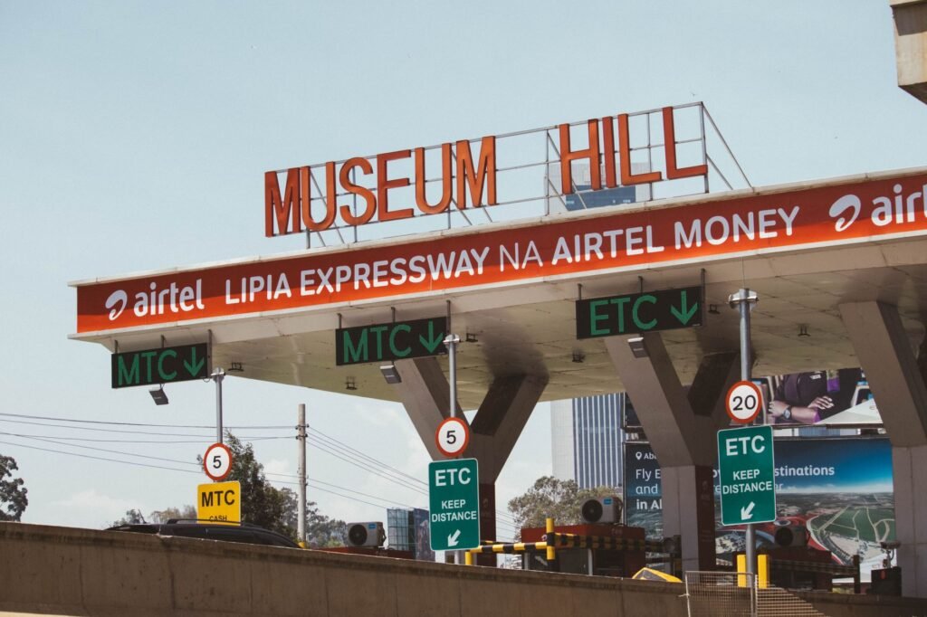 View of Museum Hill toll plaza in Nairobi, Kenya, displaying road signs and payment options.