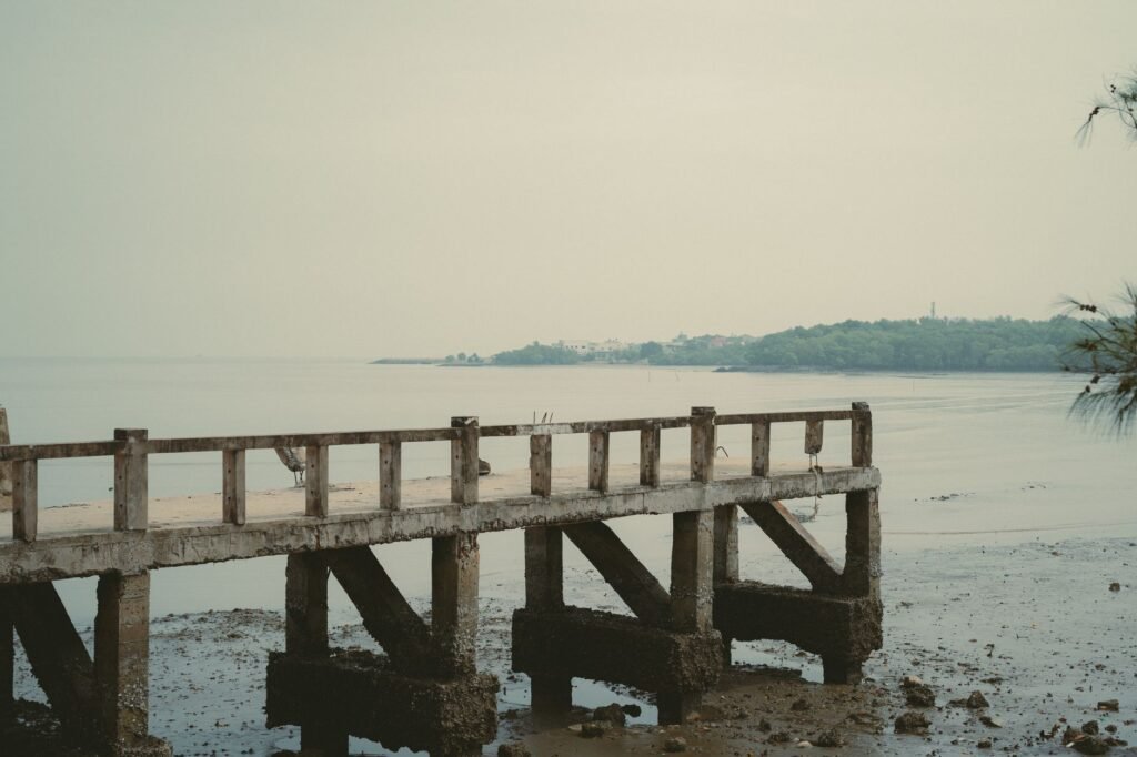 Serene image of an old pier leading into calm waters, Ho Chi Minh City, Vietnam.