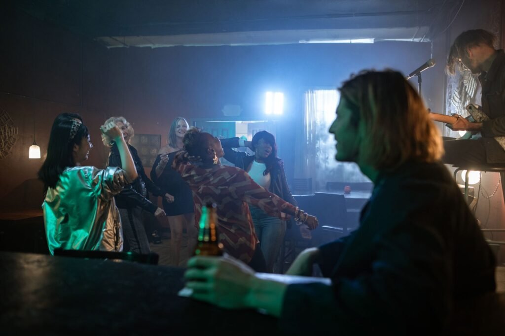 Vibrant nightclub atmosphere with diverse group dancing and live music.