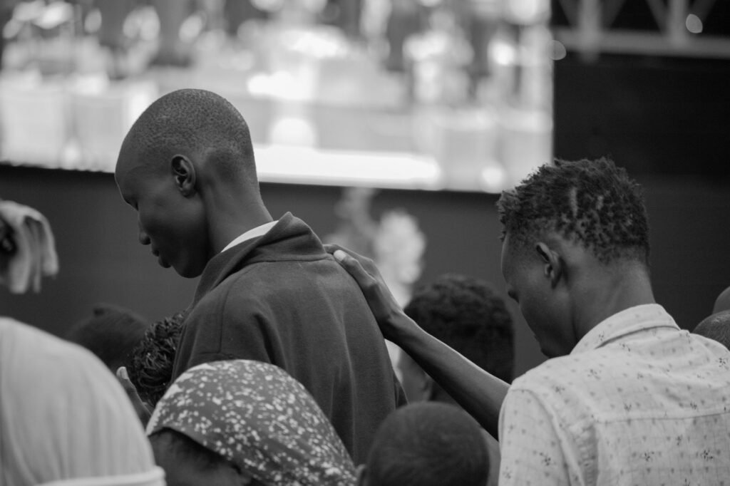 Black and white photo capturing a moment of unity and connection among a group in Nakuru, Kenya.