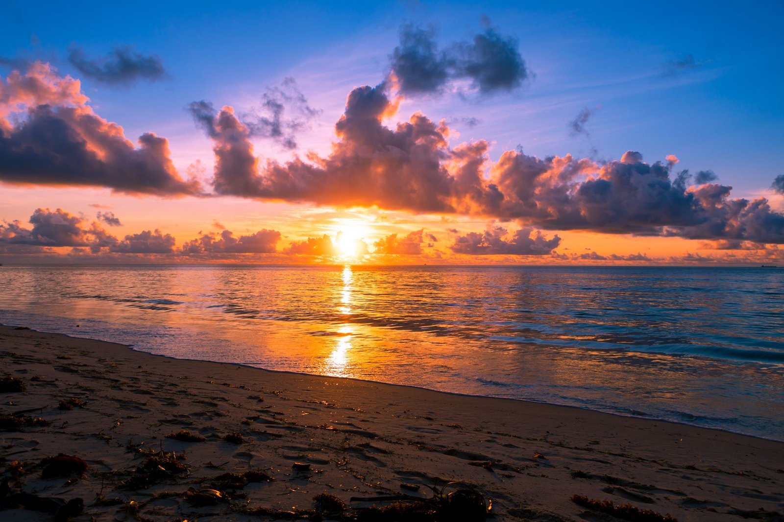Breathtaking sunrise over a serene beach in Mombasa, Kenya, with vibrant colors and calm seas.