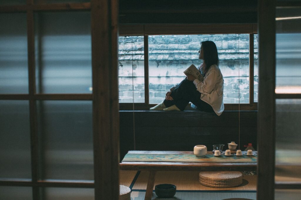 Two cups of tea on a small table in a modest private sitting room