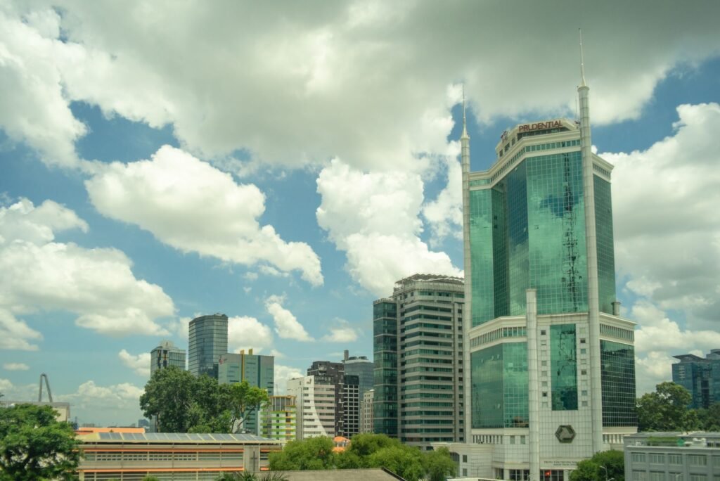 High-rise buildings against a cloudy sky in Ho Chi Minh City, showcasing modern urban architecture.