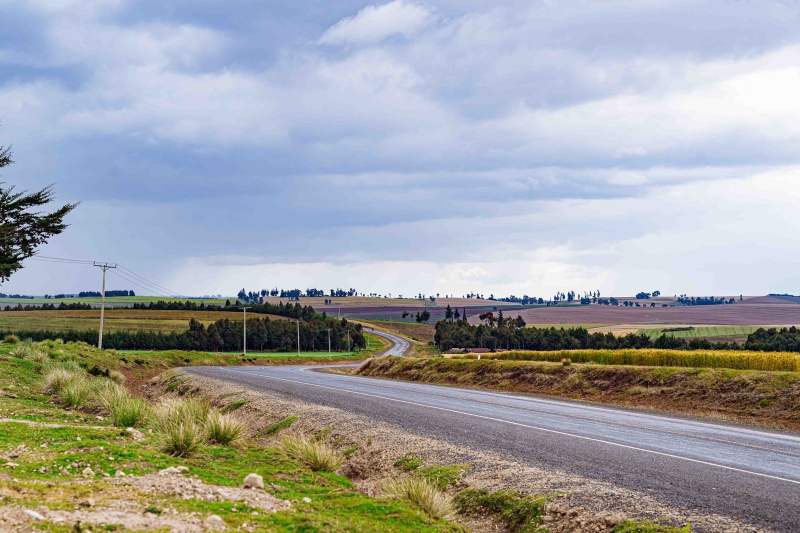 A quiet road leading towards a small town in northern Kenya at late afternoon