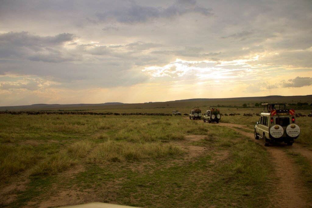 A 4x4 vehicle on a dirt track in Laikipia, Kenya, with a driver checking a phone
