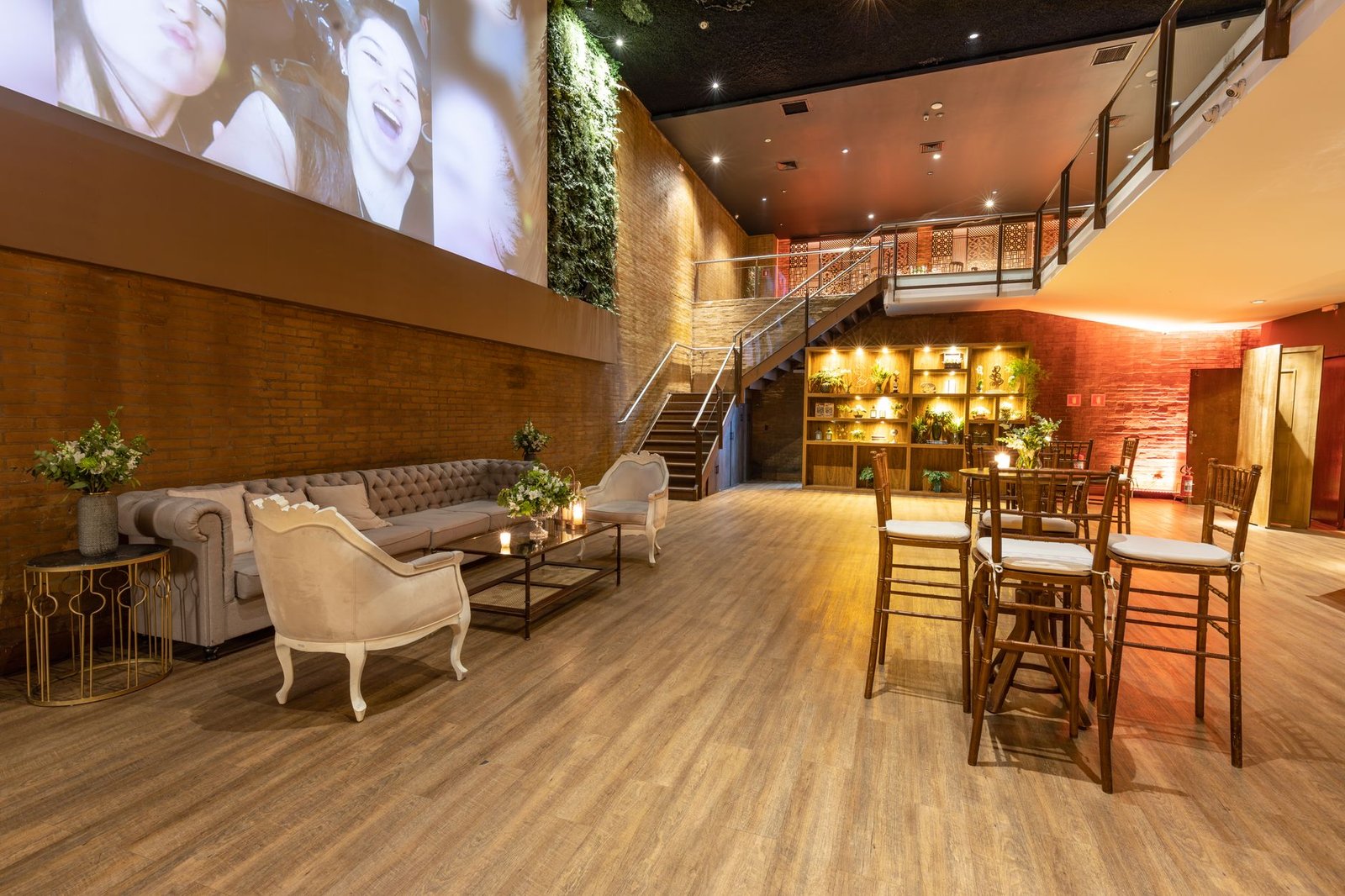 Spacious modern lounge with elegant seating, warm lighting, and decorative plants.
