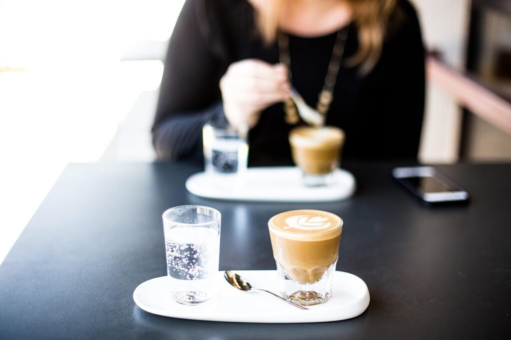 cafe, coffee cup, bar, restaurant, coffee, breakfast, cappuccino, cup, drink, glass, indoors, latte, person, plate, table