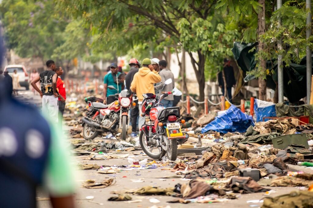 Vibrant street scene showing motorcycles, people, and urban debris, depicting daily life and challenges.