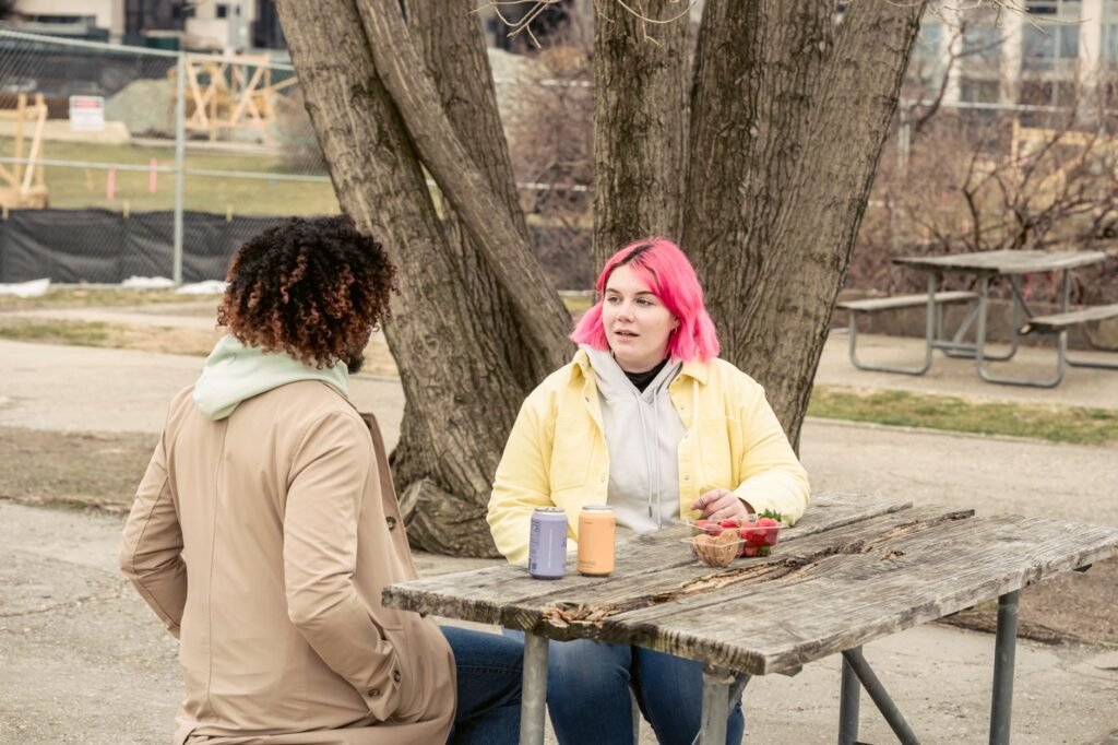 Two people in calm conversation at an outdoor café