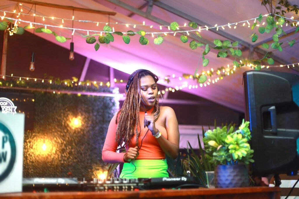 Vibrant night scene of a female DJ performing with colorful lights in South Africa.