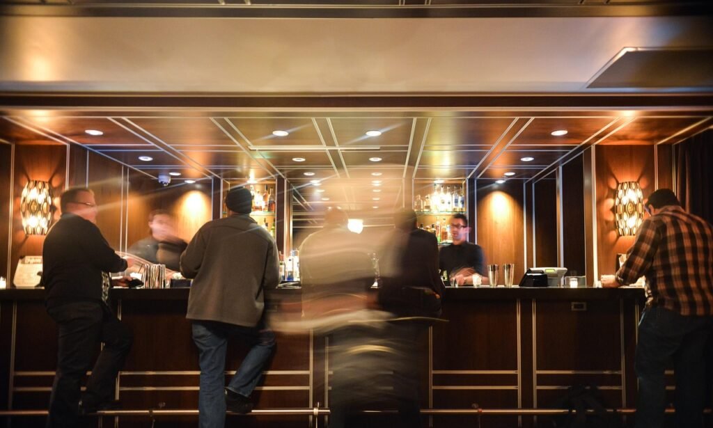 bar, nightlife, people, drinking, talking, motion, illuminated, barkeeper, pub, alcohol, indoors, lifestyle, bartender, enter