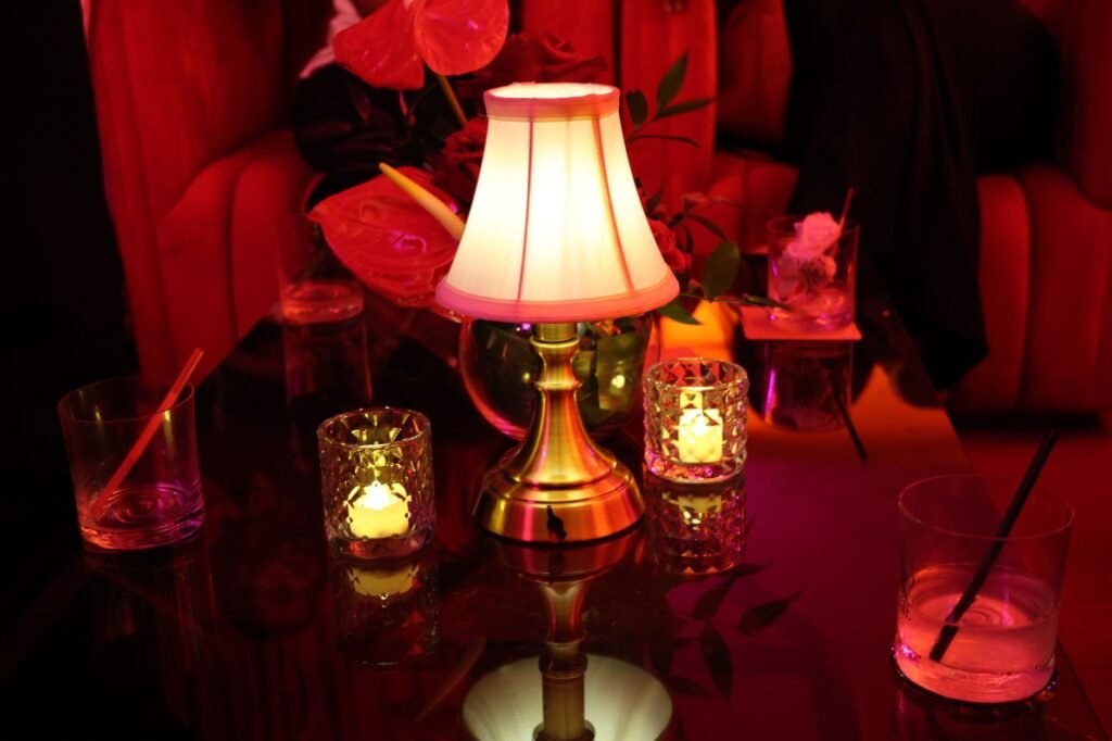 Warm ambient lighting with candles and drinks in a cozy lounge atmosphere. Perfect for intimate gatherings.