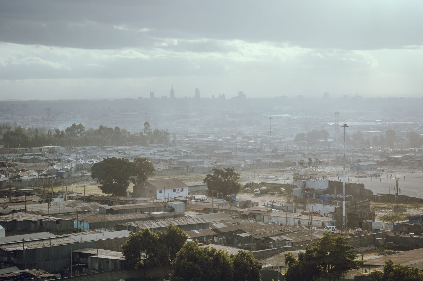 Aerial view of a foggy urban area with city skyline in the background, capturing the essence of morning atmosphere.