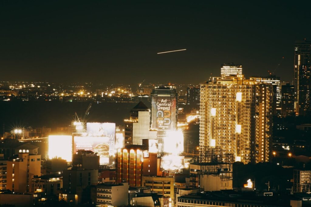 A stunning nighttime cityscape featuring illuminated skyscrapers and vibrant urban lights.