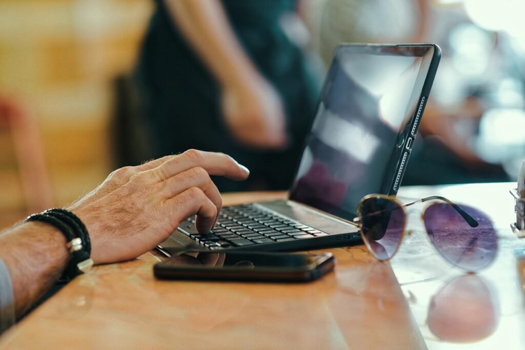 laptop, mobile, sunglasses, table, keyboard, typing, hand, arm, internet cafe, internet, cafe, business, technology, human, m