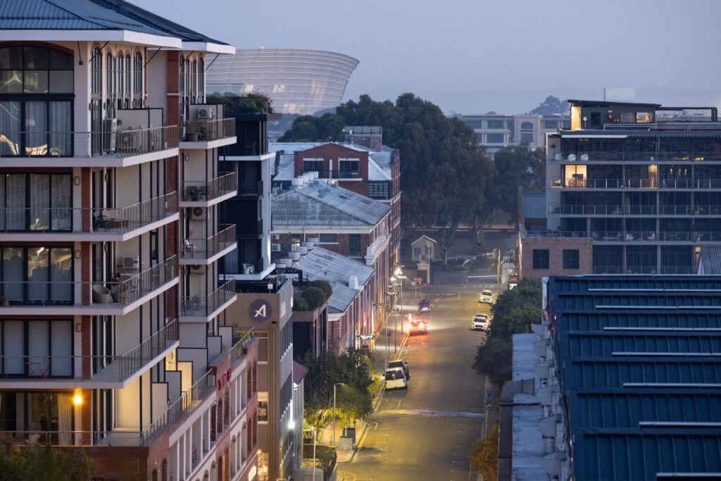 Aerial view of a city street lined with modern buildings at dusk, showcasing a serene urban landscape.