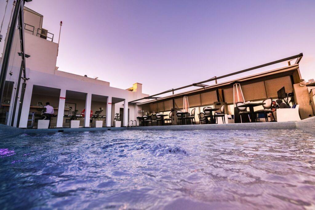 Enjoy a luxurious rooftop poolside lounge with beautiful sunset views.