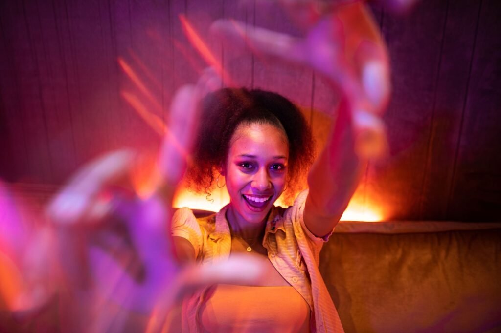 Young woman enjoying a lively night out with vibrant lighting and a joyful atmosphere.