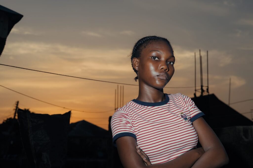 Portrait of a confident young woman at sunset outdoors.
