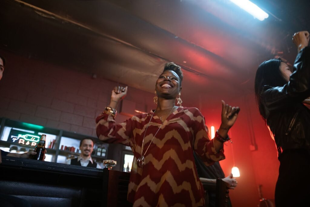 A group of adults enjoying a vibrant party at a nightclub, showcasing happiness and energy.
