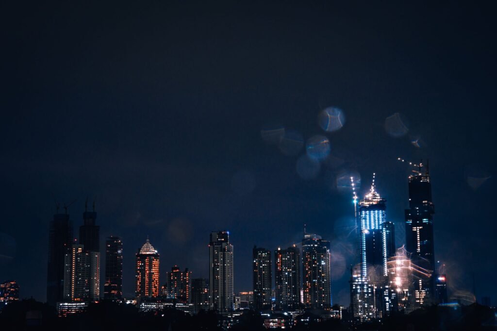 Stunning nighttime view of the Jakarta skyline featuring illuminated skyscrapers and a serene urban atmosphere.