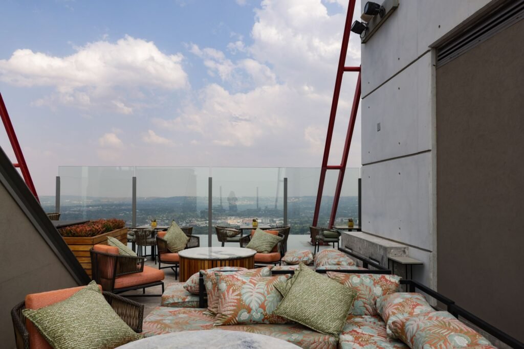 Stylish rooftop seating area offering a panoramic cityscape view with modern decor.