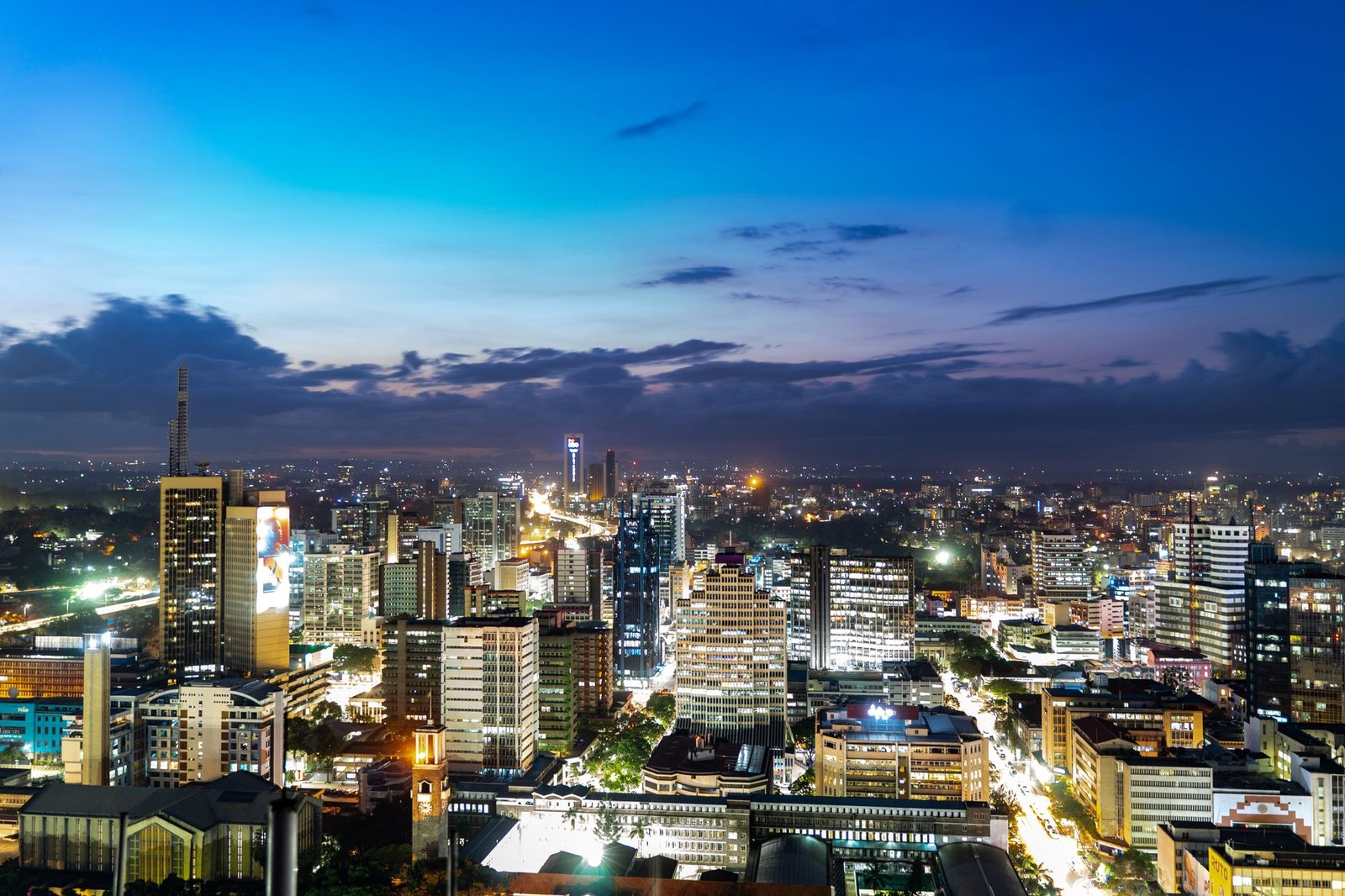 Westlands district street in Nairobi at dusk with modern buildings and pedestrians