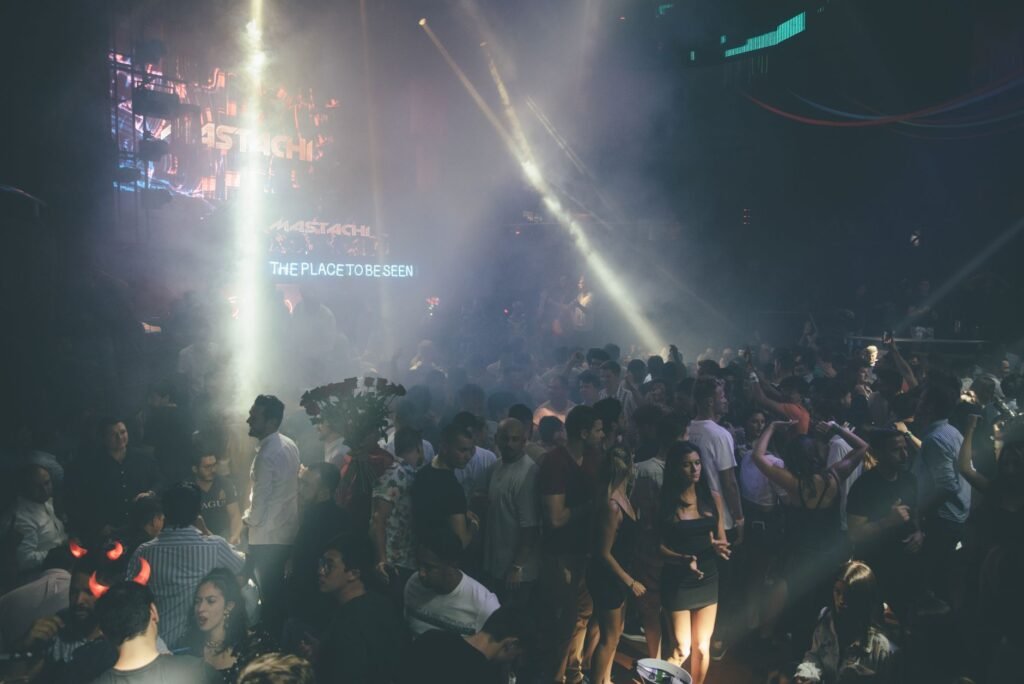 Exciting nightclub scene with a dancing crowd, vibrant lights, and music atmosphere.