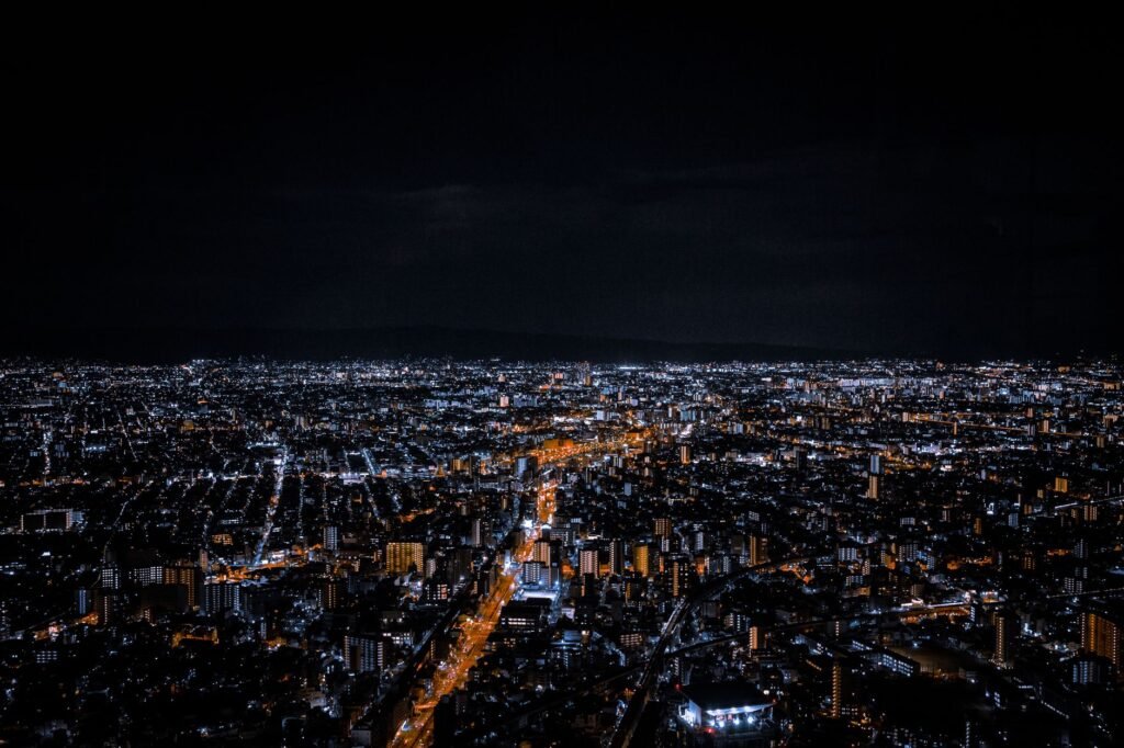Stunning aerial view of a vibrant cityscape illuminated by countless lights at night.