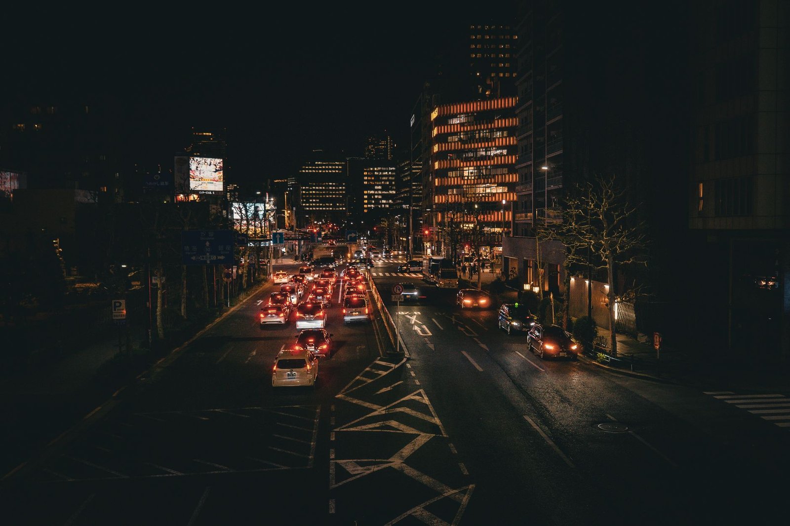 Vibrant nighttime cityscape showcasing busy Tokyo streets illuminated with city lights.